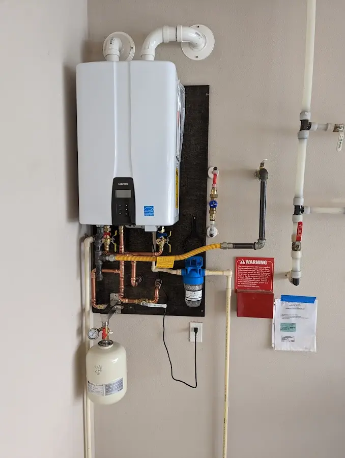 Professional plumber installing copper piping in a McGehee home